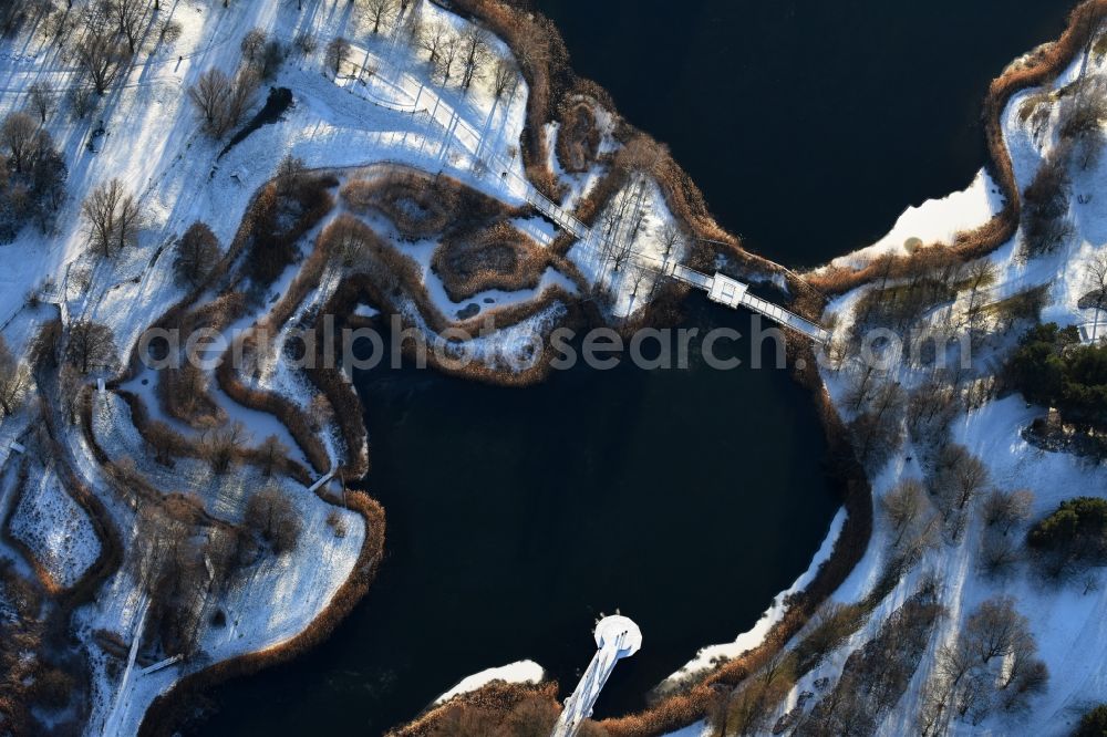 Aerial image Berlin - Wintry snowy lake area of Hauptsee in the recreation park Britz Garden in Berlin, Germany