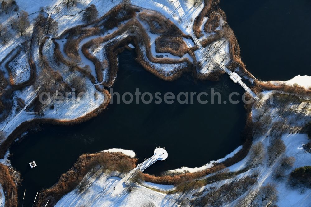 Aerial photograph Berlin - Wintry snowy lake area of Hauptsee in the recreation park Britz Garden in Berlin, Germany