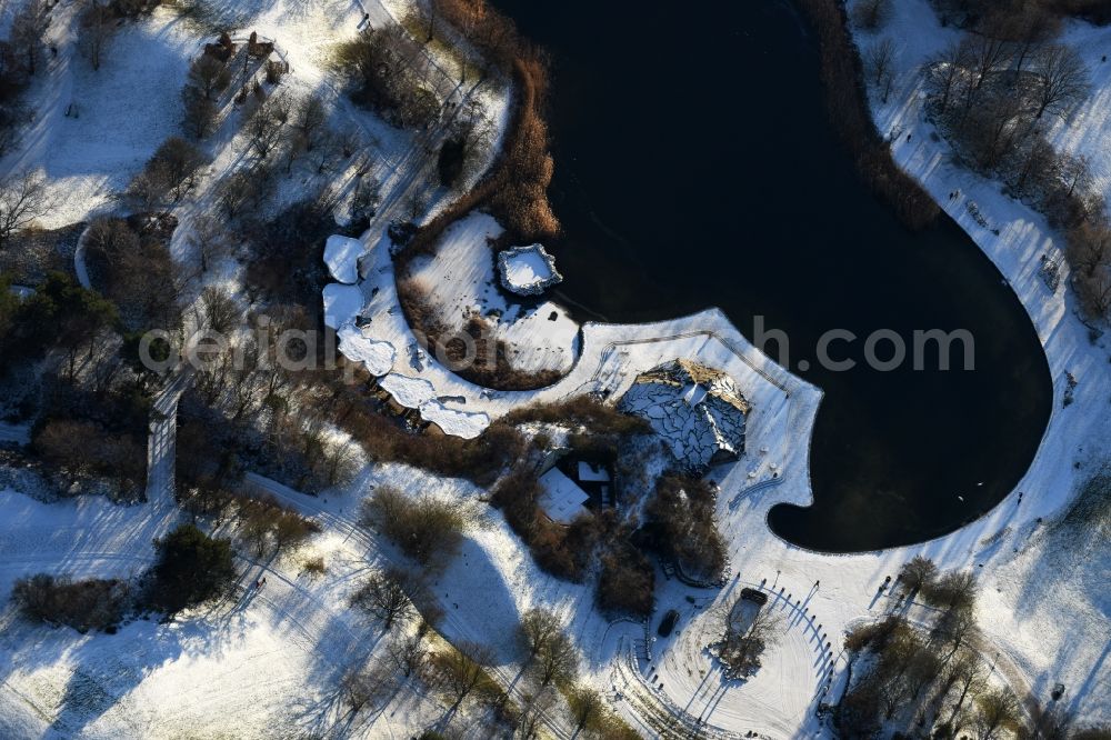 Berlin from above - Wintry snowy lake area of Hauptsee in the recreation park Britz Garden in Berlin, Germany