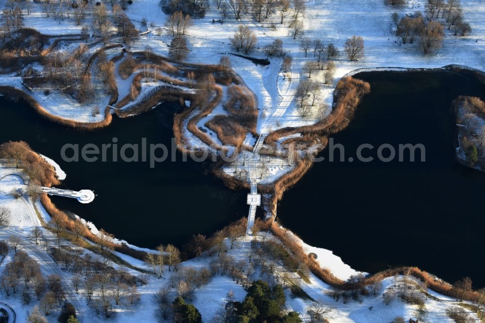 Aerial image Berlin - Wintry snowy lake area of Hauptsee in the recreation park Britz Garden in Berlin, Germany