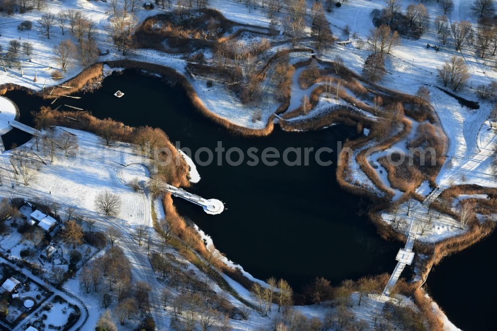 Aerial photograph Berlin - Wintry snowy lake area of Hauptsee in the recreation park Britz Garden in Berlin, Germany