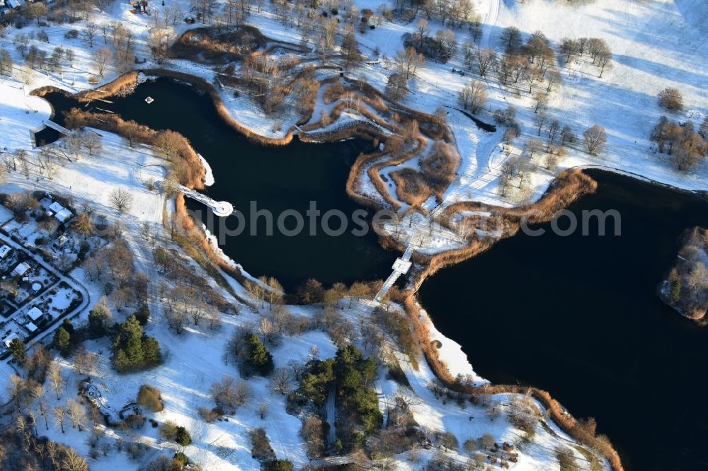 Berlin from above - Wintry snowy lake area of Hauptsee in the recreation park Britz Garden in Berlin, Germany