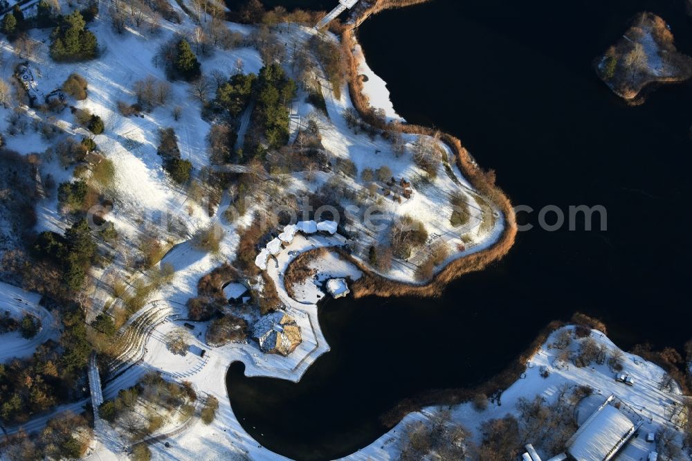 Berlin from the bird's eye view: Wintry snowy lake area of Hauptsee in the recreation park Britz Garden in Berlin, Germany