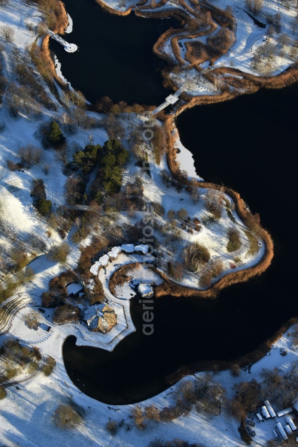 Aerial image Berlin - Wintry snowy lake area of Hauptsee in the recreation park Britz Garden in Berlin, Germany