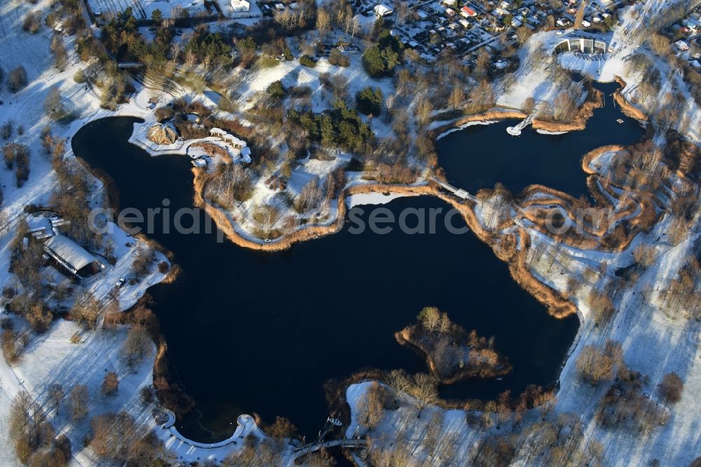 Berlin from above - Wintry snowy lake area of Hauptsee in the recreation park Britz Garden in Berlin, Germany