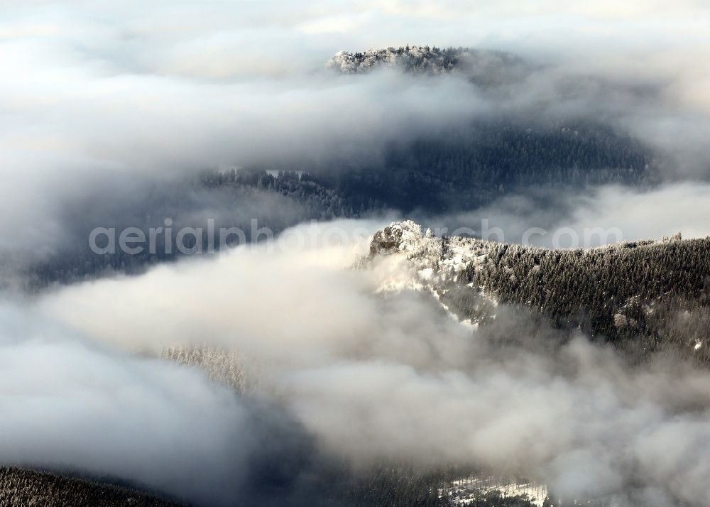 Oberhof from the bird's eye view: Winter snow covered forest landscape with rock formation Saukopf in Oberhof in Thuringia