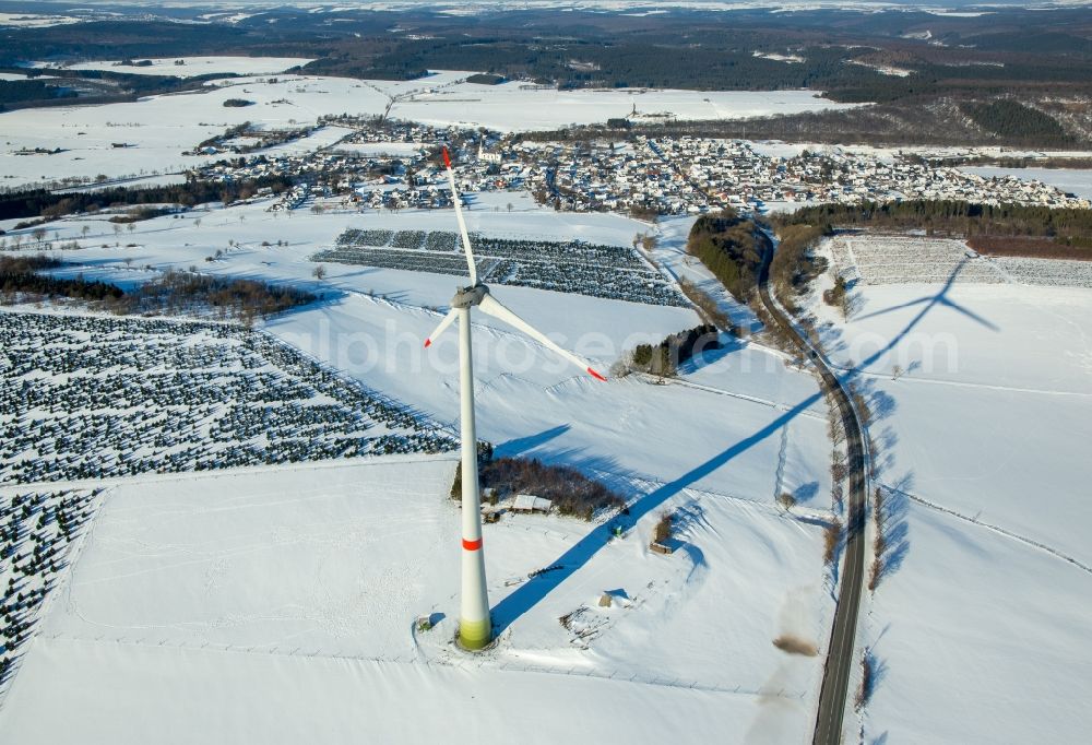 Aerial image Brilon - Wintry snowy wind turbine windmill on a field in Brilon in the state North Rhine-Westphalia