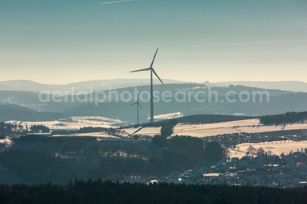 Aerial photograph Brilon - Wintry snowy wind turbine windmill on a field in Brilon in the state North Rhine-Westphalia