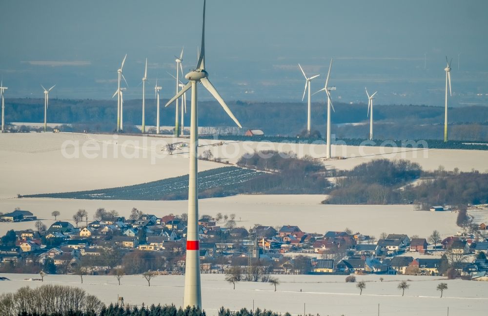 Rüthen from above - Wintry snowy wind turbine windmills on a field in Ruethen in the state North Rhine-Westphalia