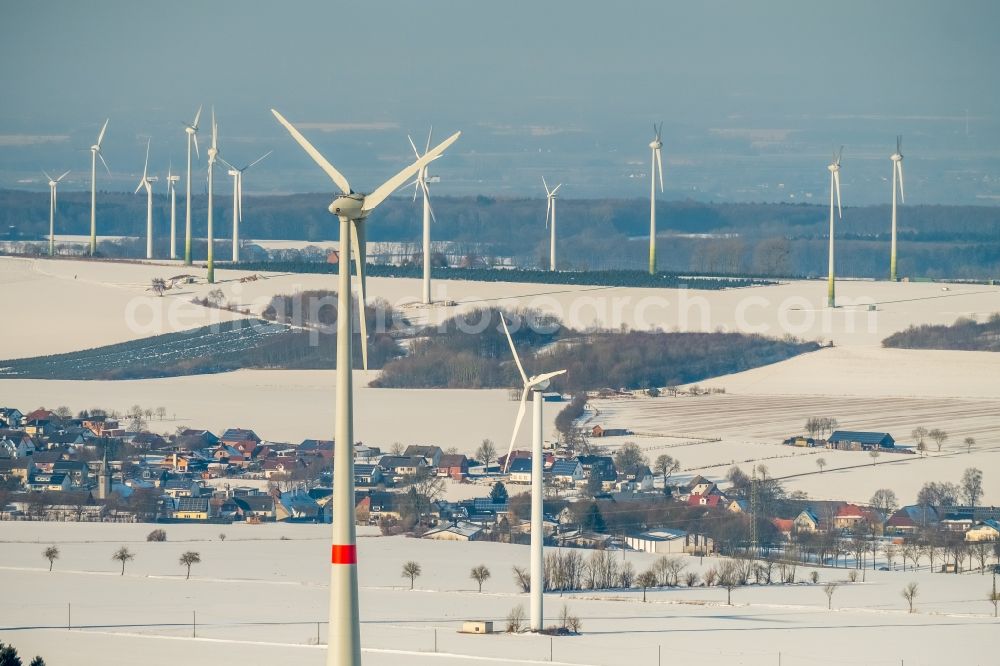 Aerial image Rüthen - Wintry snowy wind turbine windmills on a field in Ruethen in the state North Rhine-Westphalia