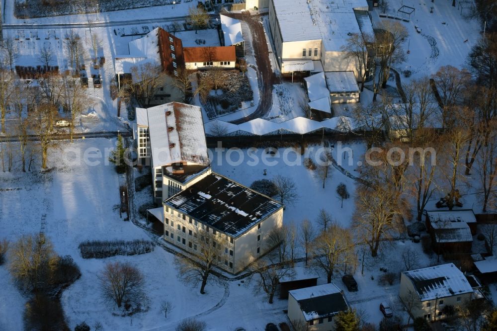 Aerial image Päwesin - Wintry snow-covered building complex of the hotel Bollmansruh on Lake Beetzsee in Bollmannsruh in the state of Brandenburg