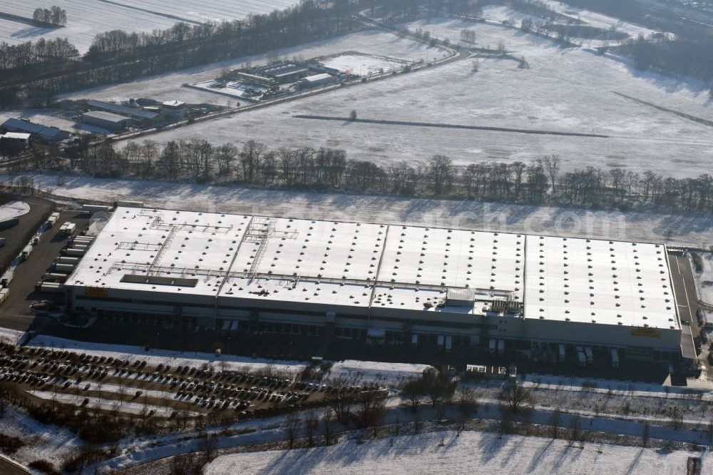 Berlin from the bird's eye view: Wintry snowy building complex and distribution center on the site of Netto Marken-Discount on Arkenberger Damm in Berlin in Germany