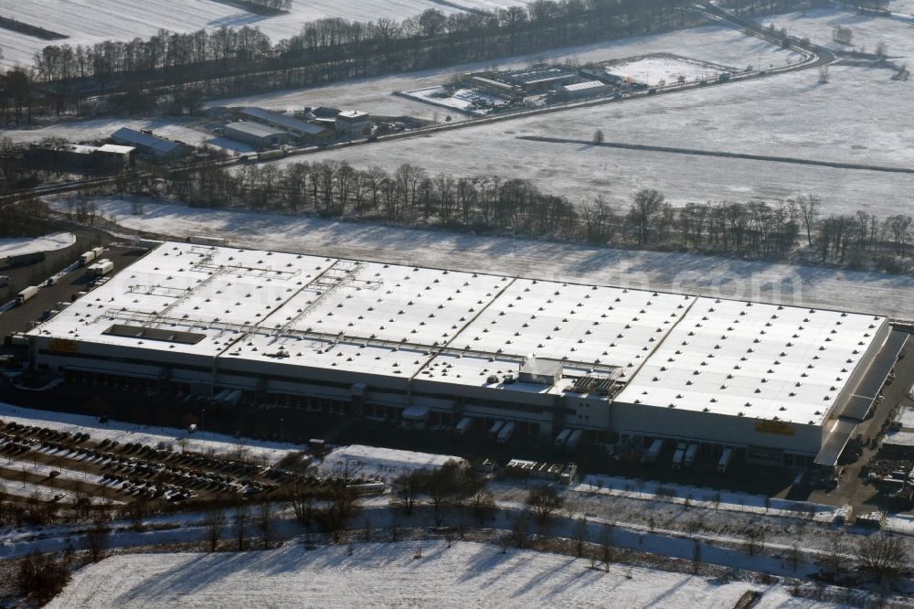 Aerial image Berlin - Wintry snowy building complex and distribution center on the site of Netto Marken-Discount on Arkenberger Damm in Berlin in Germany