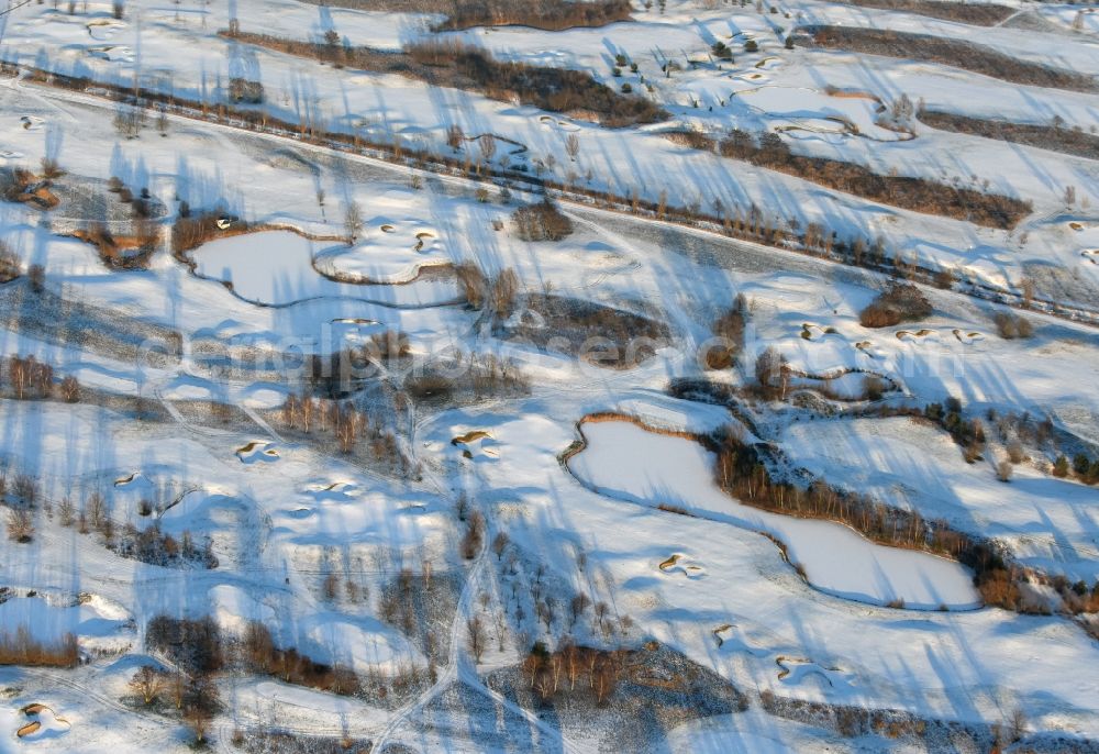 Hohen Neuendorf from the bird's eye view: Wintry snowy grounds of the Golf course at Berliner Golfclub Stolperheide e.V. in Hohen Neuendorf in the state Brandenburg