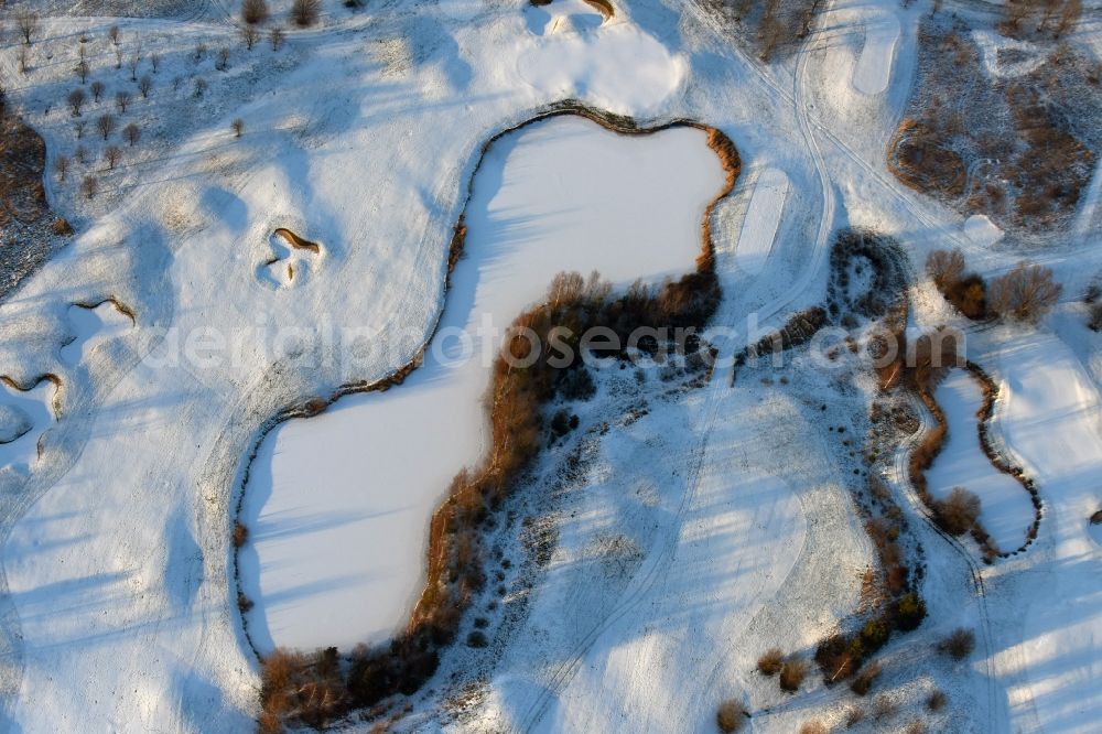 Hohen Neuendorf from the bird's eye view: Wintry snowy grounds of the Golf course at Berliner Golfclub Stolperheide e.V. in Hohen Neuendorf in the state Brandenburg