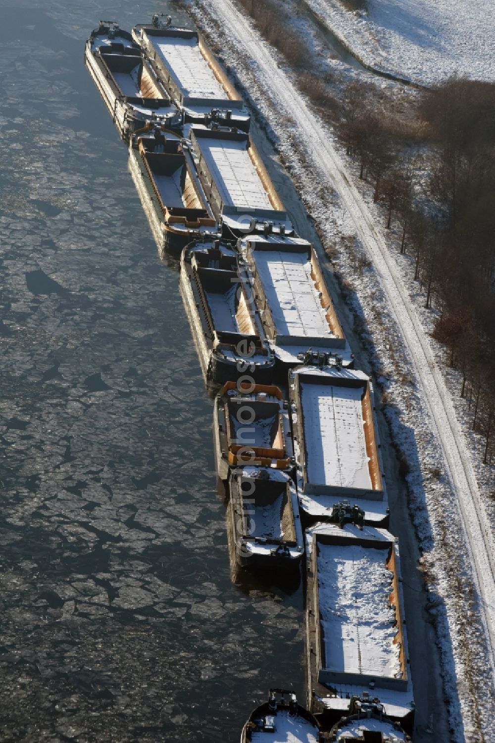 Aerial image Burg - Wintry snowy channel course with moored barge inland thrust units on the banks of the Elbe-Havel Canal in Burg in Saxony-Anhalt