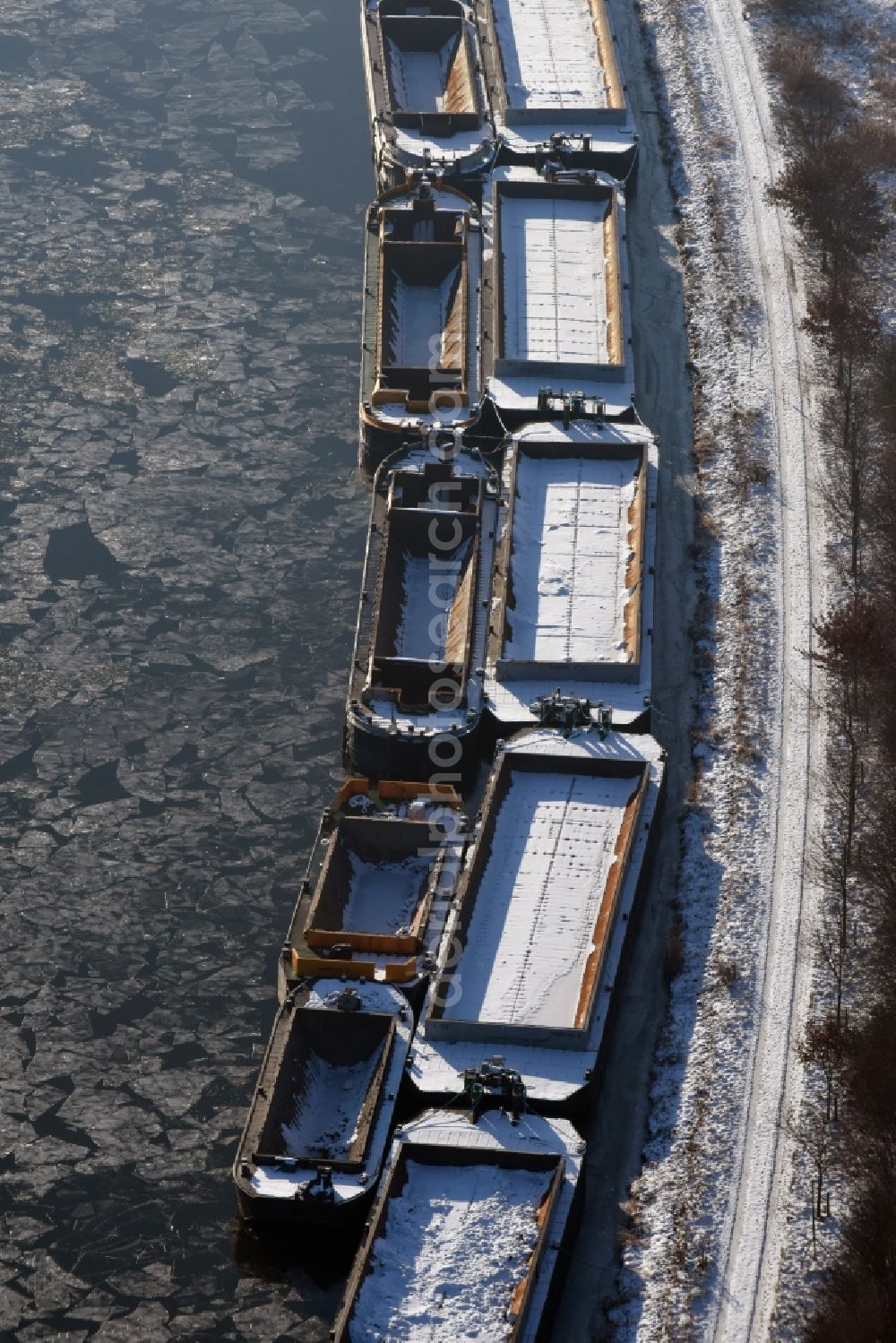 Aerial photograph Burg - Wintry snowy channel course with moored barge inland thrust units on the banks of the Elbe-Havel Canal in Burg in Saxony-Anhalt