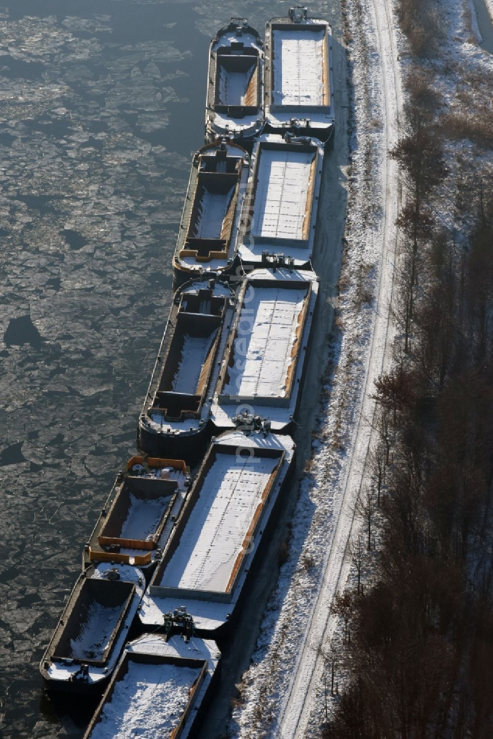 Burg from above - Wintry snowy channel course with moored barge inland thrust units on the banks of the Elbe-Havel Canal in Burg in Saxony-Anhalt