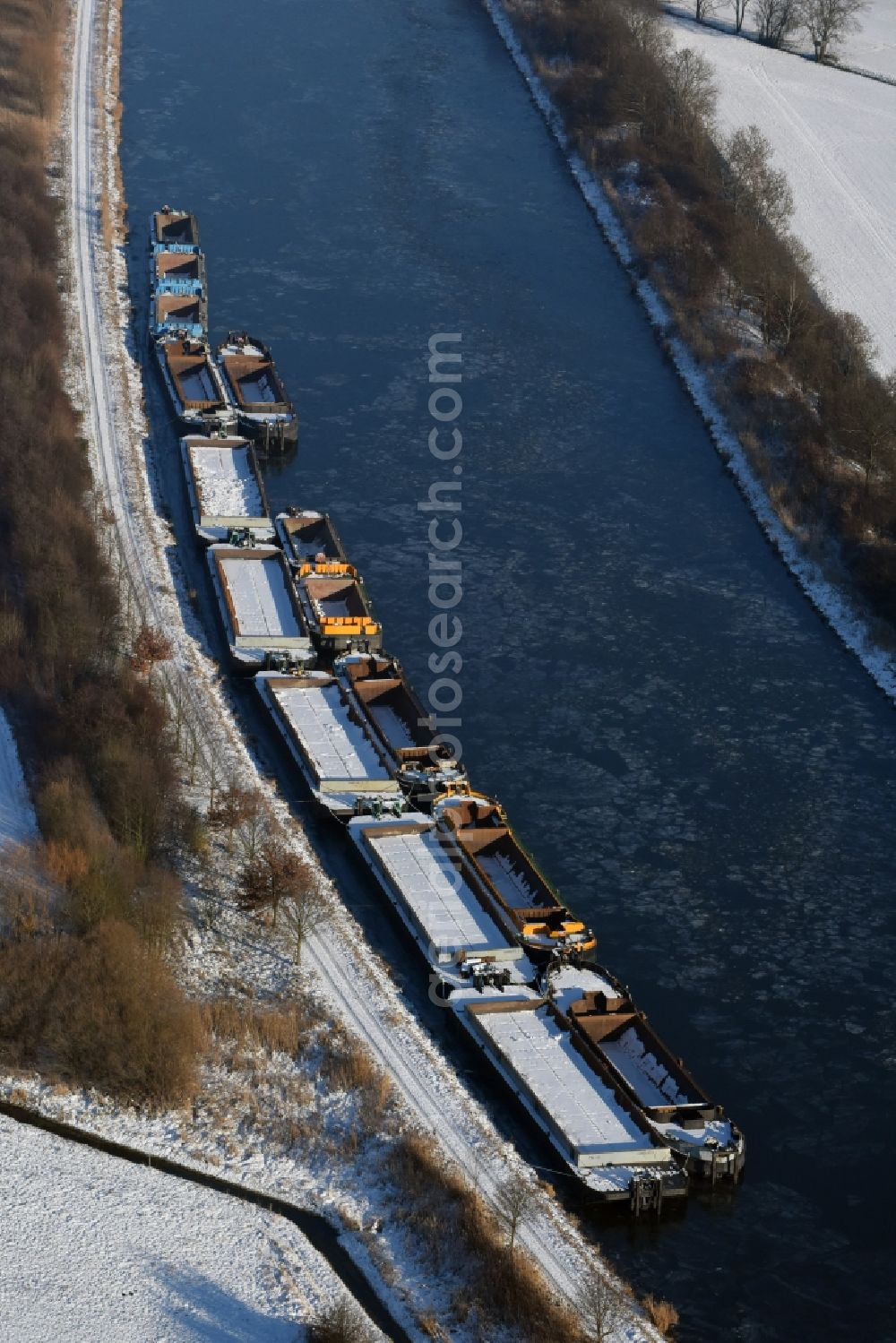 Aerial photograph Burg - Wintry snowy channel course with moored barge inland thrust units on the banks of the Elbe-Havel Canal in Burg in Saxony-Anhalt