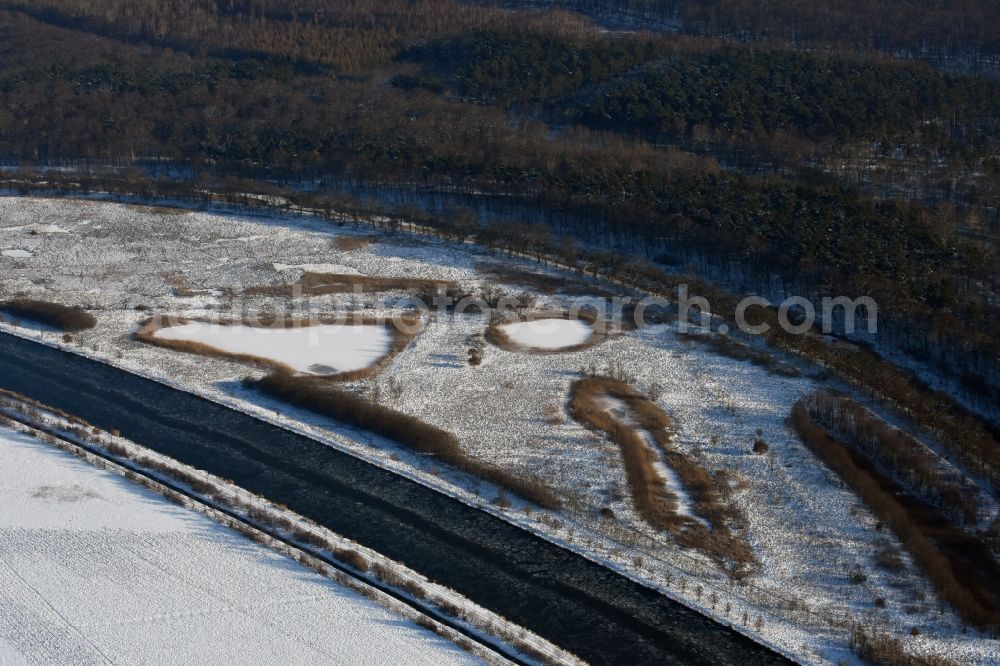 Burg from the bird's eye view: Wintry snowy channel course and riparian areas on renatured Altarm the Elbe-Havel Canal near Burg in Saxony-Anhalt