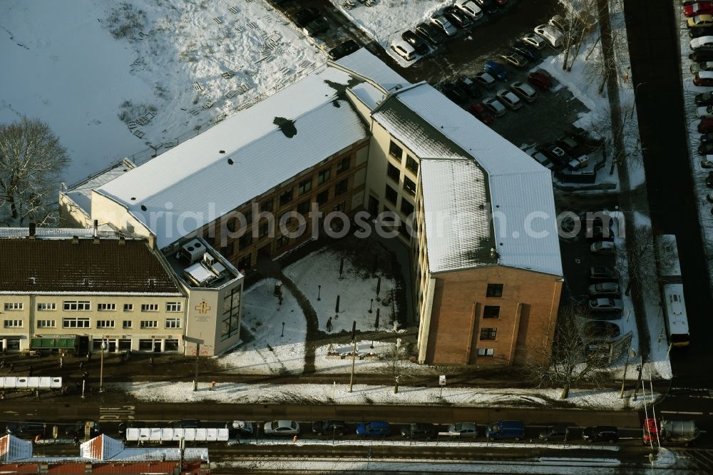 Berlin from the bird's eye view: Wintry snowy site to build a new health center at the street corner Mahlsdorfer Kaulsdorfer street in Berlin - Koepenick