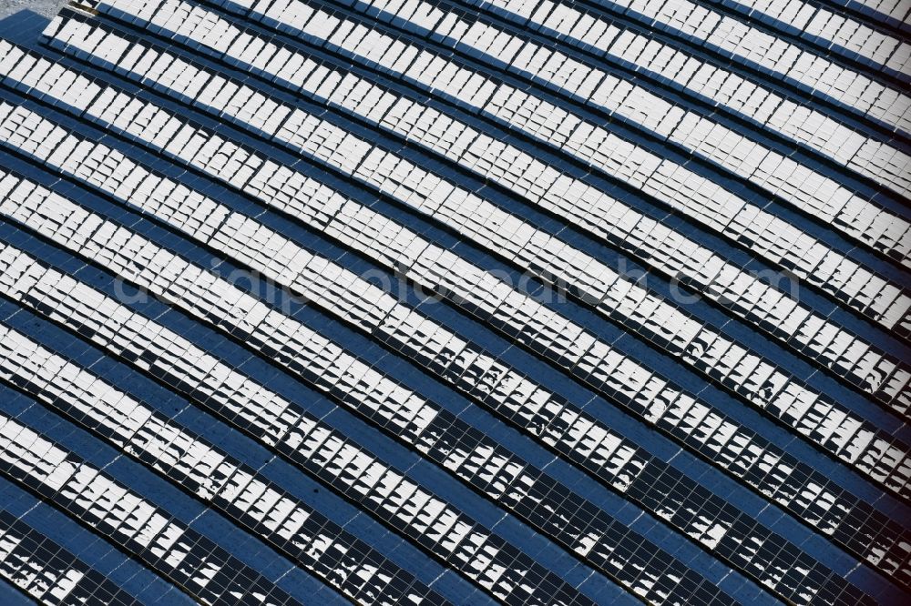 Aerial photograph Werneuchen - Wintry snowy panel rows of photovoltaic and solar farm or solar power plant in Werneuchen in the state Brandenburg