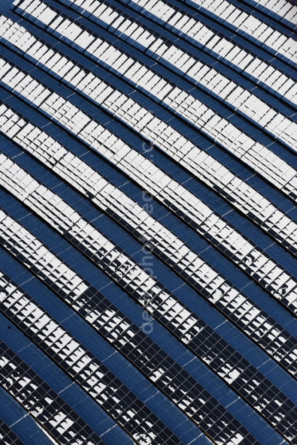 Werneuchen from above - Wintry snowy panel rows of photovoltaic and solar farm or solar power plant in Werneuchen in the state Brandenburg