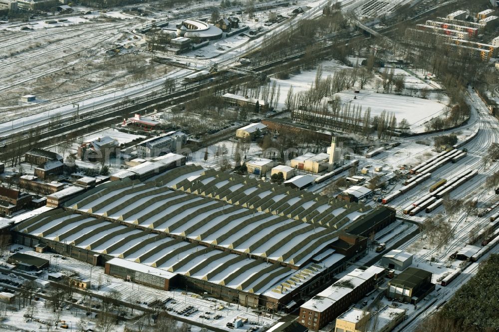 Berlin from above - Wintry snowy railway depot and repair shop for maintenance and repair of trains of passenger transport of the series S-Bahn train in Berlin in Germany