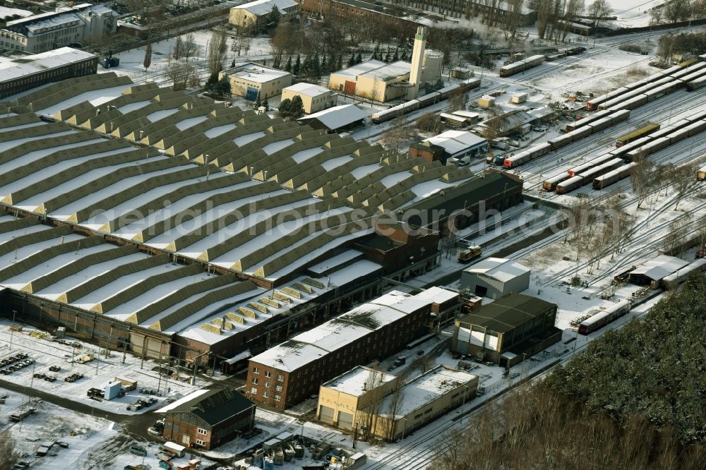 Berlin from the bird's eye view: Wintry snowy railway depot and repair shop for maintenance and repair of trains of passenger transport of the series S-Bahn train in Berlin in Germany