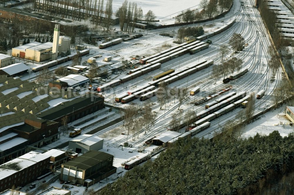 Aerial image Berlin - Wintry snowy railway depot and repair shop for maintenance and repair of trains of passenger transport of the series S-Bahn train in Berlin in Germany