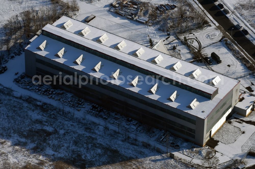 Brandenburg an der Havel from the bird's eye view: Wintry snow-covered company building of Hoch und Ingenieurbaugesellschaft mbH HIB construction company in Brandenburg an der Havel in the state of Brandenburg. The large hall of the company is located on Carl-Reichstein-Strasse