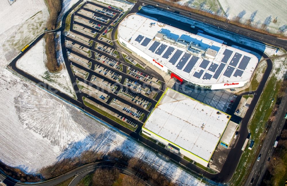 Hamm from the bird's eye view: Wintry snowy building of the store - furniture market finke Das Erlebnis-Einrichten GmbH & Co. KG in Hamm in the state North Rhine-Westphalia