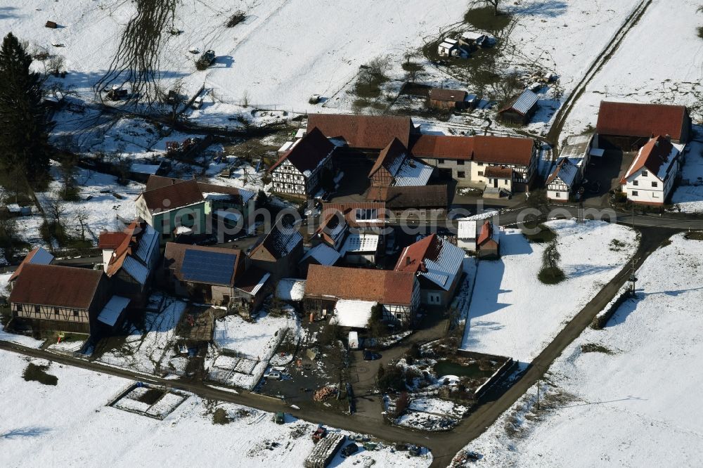 Aerial image Weilar - Wintry snowy Farm on the edge of cultivated fields in Weilar in the state Thuringia