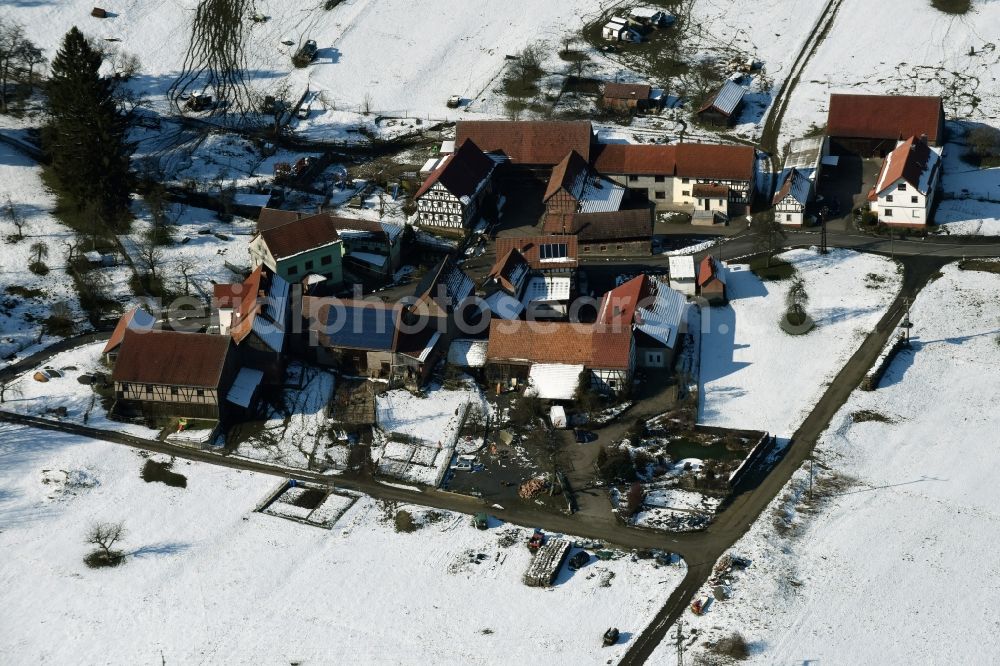 Aerial photograph Weilar - Wintry snowy Farm on the edge of cultivated fields in Weilar in the state Thuringia