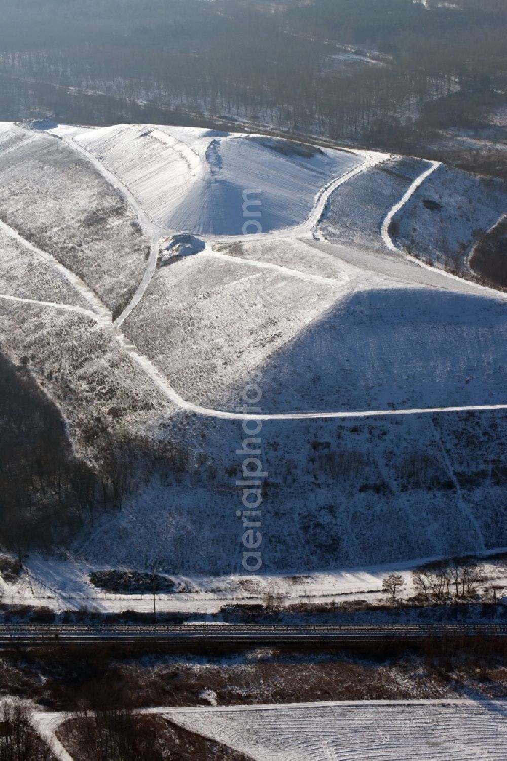 Berlin from the bird's eye view: Wintry snowy site of heaped landfill in Berlin in Germany