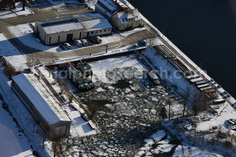 Aerial image Brandenburg an der Havel - Winterly snowy building yard of the Wasser- und Schifffahrtsamt with frozen pier for in-house ships in Brandenburg an der Havel in the state Brandenburg