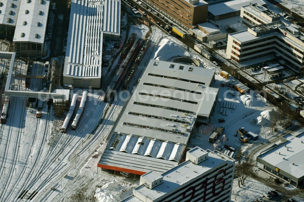 Aerial image Berlin - Wintry snowy terrain Construction site for new construction building of the construction market of OBI GmbH & Co. Deutschland KG an der Buchberger Strasse im Stadtteil Lichtenberg in Berlin in Germany