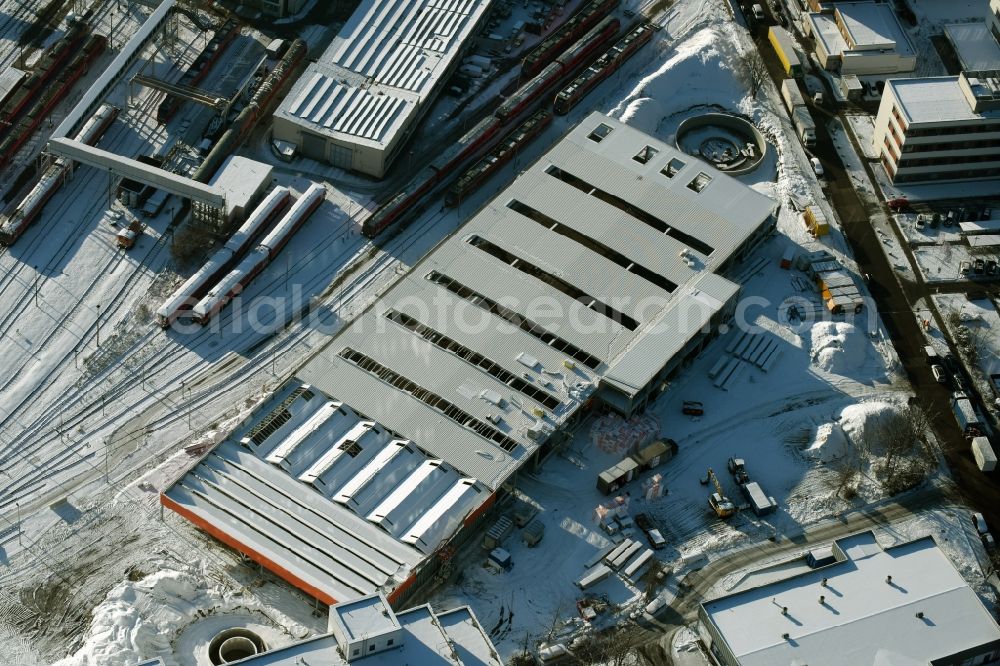 Aerial photograph Berlin - Wintry snowy terrain Construction site for new construction building of the construction market of OBI GmbH & Co. Deutschland KG an der Buchberger Strasse im Stadtteil Lichtenberg in Berlin in Germany