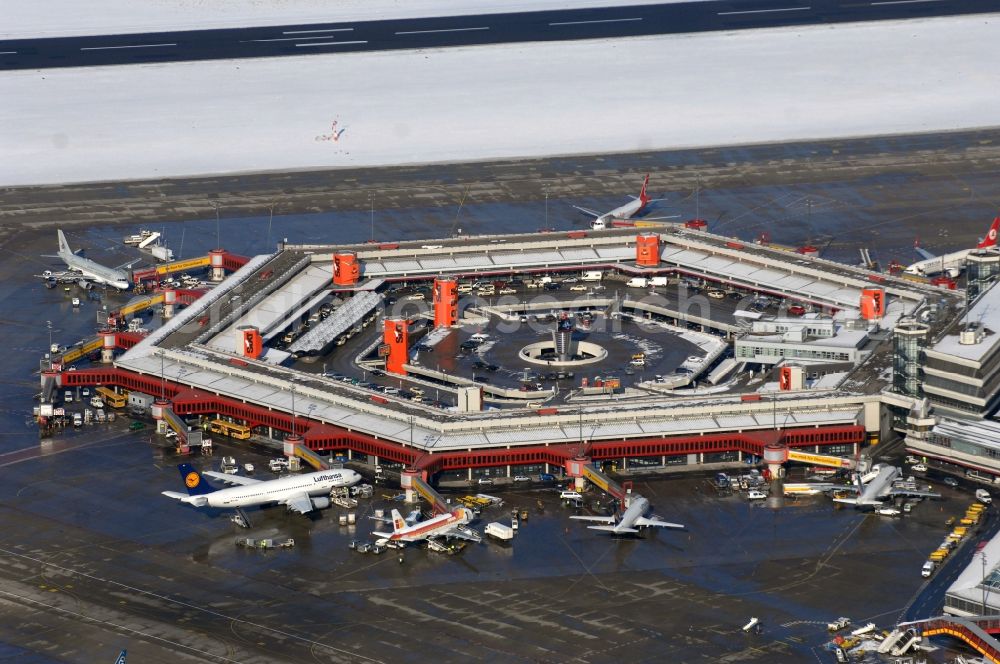 Aerial photograph Berlin - Wintry snowy Runway with hangar taxiways and terminals on the grounds of the airport in Berlin