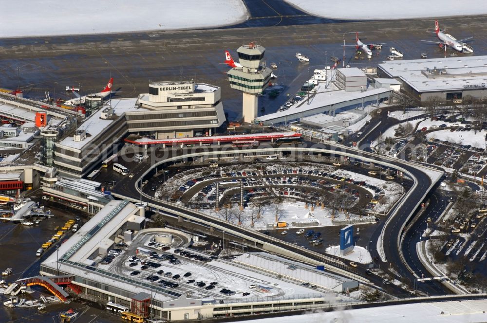 Aerial image Berlin - Wintry snowy Runway with hangar taxiways and terminals on the grounds of the airport in Berlin