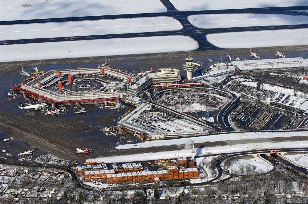 Aerial photograph Berlin - Wintry snowy Runway with hangar taxiways and terminals on the grounds of the airport in Berlin