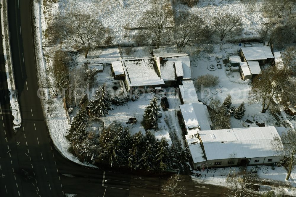 Hoppegarten from the bird's eye view: Wintry snowy administration building of the company Forst-Garten & Kommunal-Technik Fehrmann an der Koepenicker Strasse in Hoppegarten in the state Brandenburg