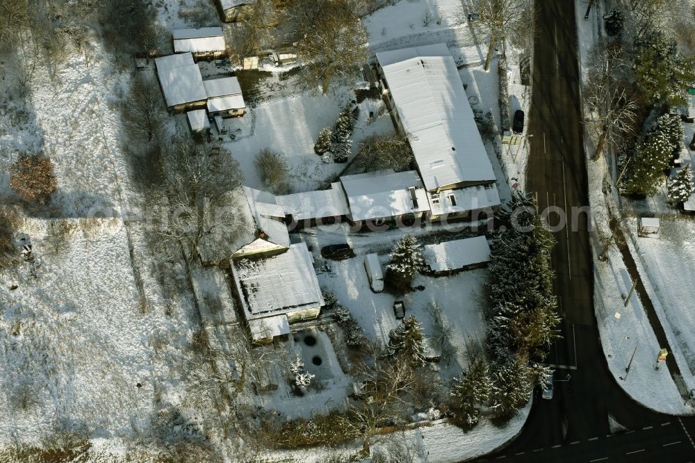 Hoppegarten from above - Wintry snowy administration building of the company Forst-Garten & Kommunal-Technik Fehrmann an der Koepenicker Strasse in Hoppegarten in the state Brandenburg