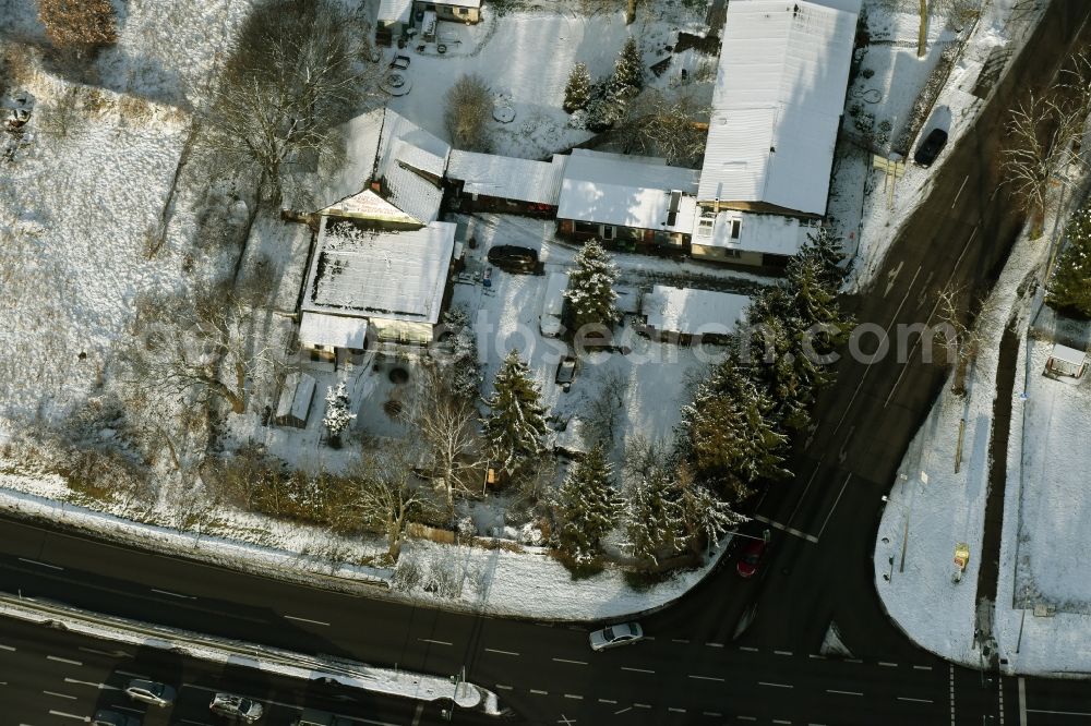 Hoppegarten from the bird's eye view: Wintry snowy administration building of the company Forst-Garten & Kommunal-Technik Fehrmann an der Koepenicker Strasse in Hoppegarten in the state Brandenburg