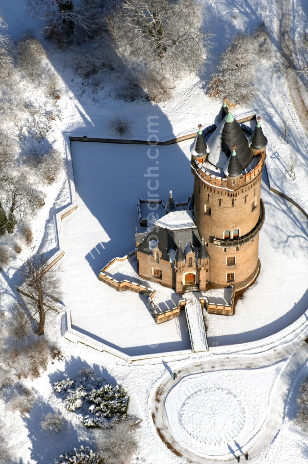 POTSDAM from above - Blick auf den winterlich verschneiten Flatowturm im Park Babelsberg. Der Turm wurde in den Jahren 1853-1856 nach Plänen des Architekten Strack und unter der Leitung von Martin Gottgetreu errichtet. Der Flatowturm ist ein 46 Meter hoher Wohnturm. Kontakt: Stiftung Preußische Schlösser und Gärten Berlin-Brandenburg, 14414 Potsdam, Tel. 0331 9694 0, Fax 0331 9694 107