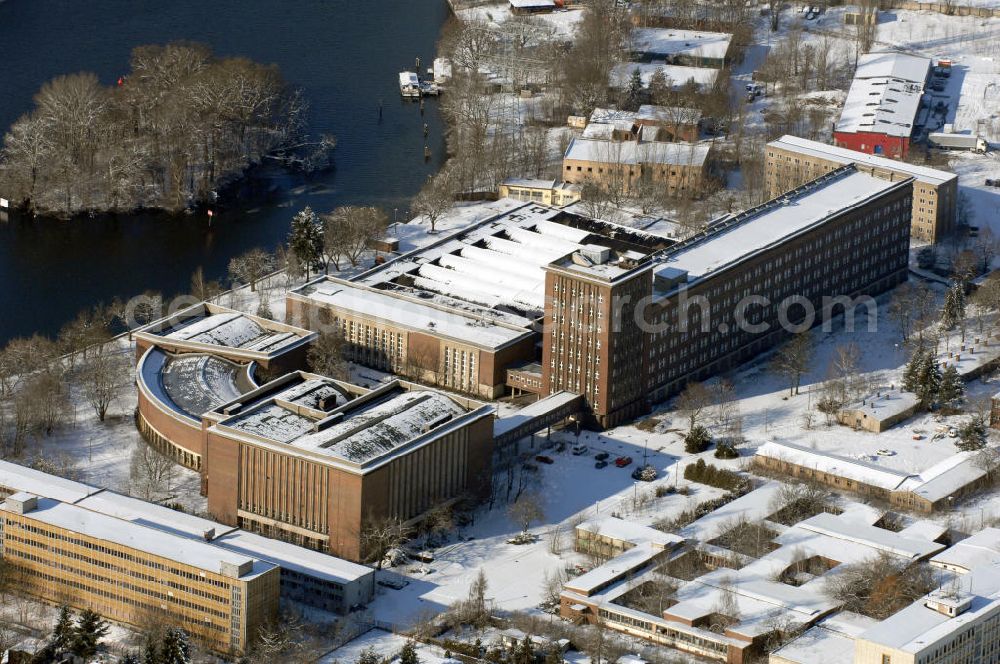 Aerial image Berlin - Blick auf das winterlich verschneite Rundfunkzentrum Nalepastrasse. Es zählt zu den bedeutensten Funkbauten der DDR. Hier wurden Maßstäbe für die Rundfunkkultur gesetzt. Dieses mächtige Medium war sowohl Propagandamittel im Kampf der Systeme und Mittel zur Darstellung nach außen als auch nicht zu unterschätzender Kulturträger in der Gesellschaft der DDR. Es ist fast vollständig - bis auf die elektronische Einrichtung - im Zustand der Erbauungszeit erhalten. Man findet hier zum Beispiel Musikaufnahme- und Hörspielstudios. Wegen ihrer sehr guten akustischen Eigenschaften sind die Studios und die Aufnahmesäle für jede Art von Tonaufnahmen auch heute noch nutzbar. Zur Zeit steht das Gebäude leer.