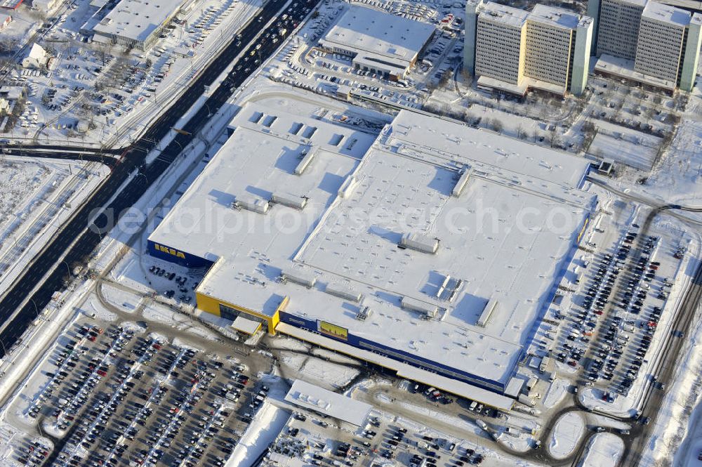 Berlin from the bird's eye view: Winterlich verschneiter IKEA-Neubau Berlin Lichtenberg an der Landsberger Allee , dem zweitgrößte Ikea-Standort in Europa mit 22 000 Quadratmetern und zugleich dem dritten Berliner Einrichtungshaus. View of the IKEA store area in Berlin Lichtenberg. It is the third furniture store in Berlin.