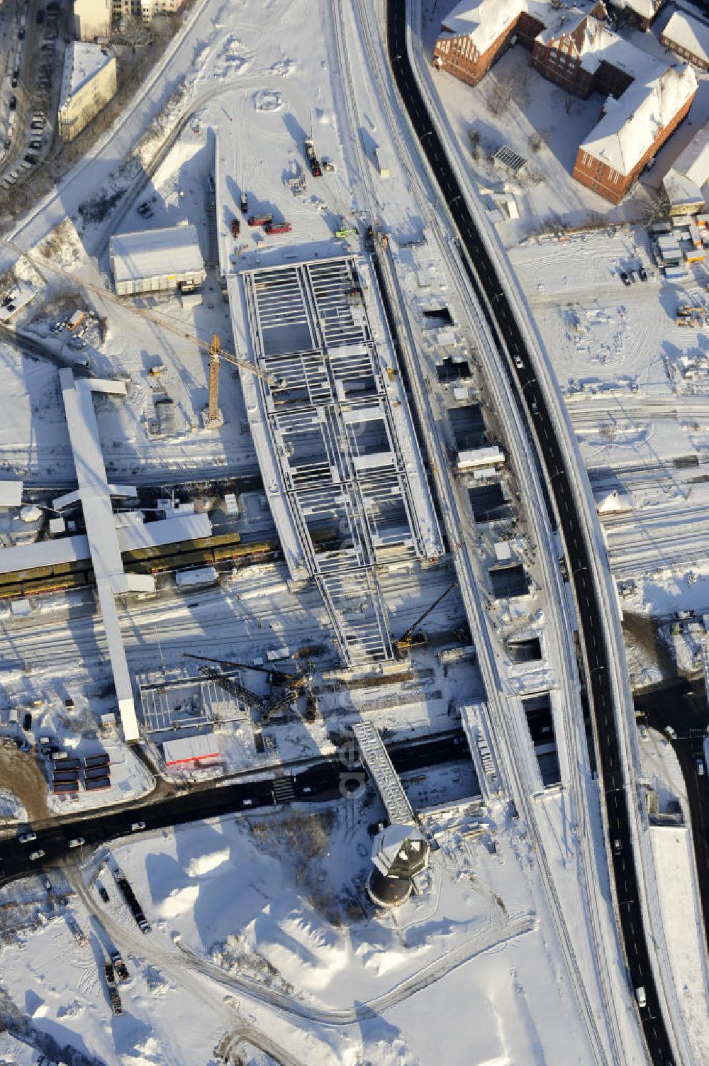 Berlin from above - Winterlich verschneiter Blick auf den Um- und Neubau des Berliner S-Bahnhof Ostkreuz der Deutschen Bahn. Teile der Neubauten führt die EUROVIA Beton GmbH aus. Weiterhin beteiligt ist das Unternehmen VEPRO Verkehrsbauprojekt GmbH. Upgrading and construction of the Berlin S-Bahn station Ostkreuz.