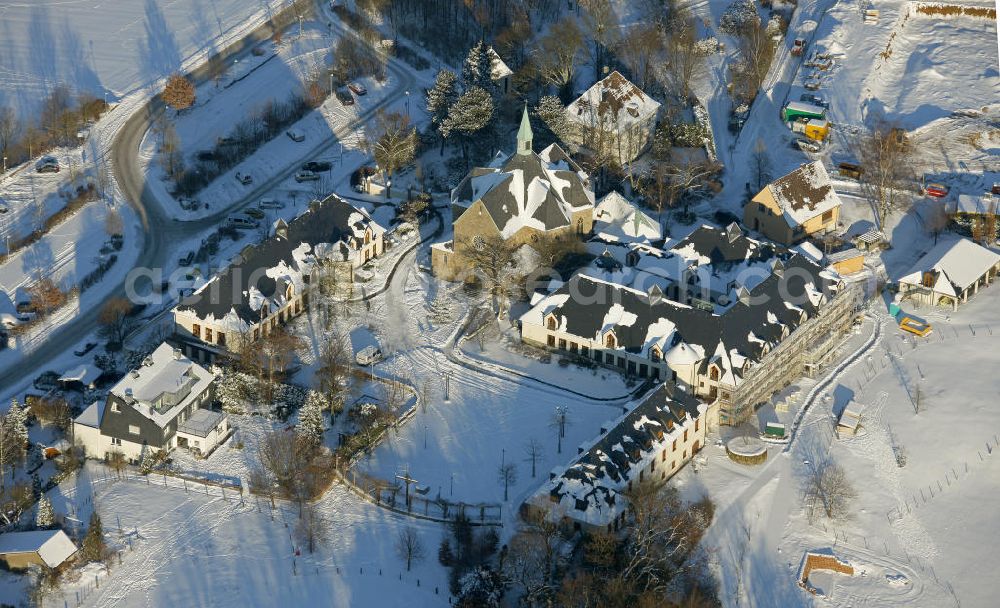 Aerial photograph Bochum - Blick auf das winterlich verschneite Kloster Stiepel in Bochum, Nordrhein-Westfalen. Das Kloster wurde 1988 gegründet und untersteht dem Abt von Stift Heiligenkreuz, einer Abtei in Österreich. Das Kloster gilt als ein Wallfahrtsort der katholischen Kirche. View of the snowy winter monastery Stiepel in Bochum, North Rhine-Westphalia. The monastery was founded in 1988 and is subject to the Abbot of Heiligenkreuz, a monastery in Austria. The monastery is a place of pilgrimage of the Catholic Church.