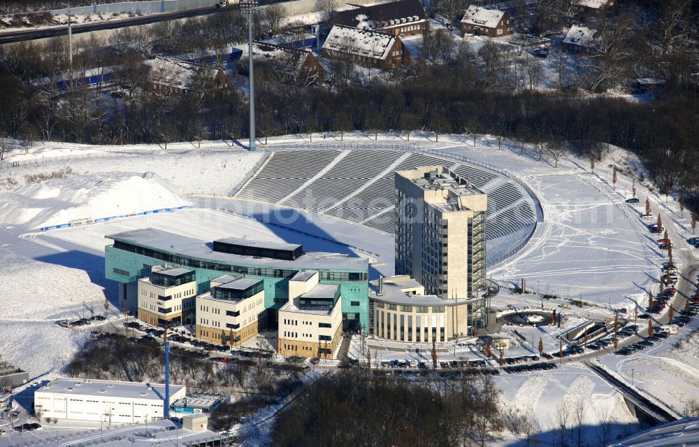 Aerial image Gelsenkirchen - Blick auf das winterlich verschneite Vereinsgelände des FC Schalke 04 und des Medico Reha Zentrum in Gelsenkirchen, Nordrhein-Westfalen. Zu sehen ist die Südkurve des alten Parkstadions des FC Schalke 04, das moderne Medicos Reha Zentrum, ein Hotel und ein Restaurant. View of the snowy winter sports facilities of FC Schalke 04 and the Medico Rehabilitation Center in Gelsenkirchen, North Rhine-Westphalia. You can see the South Stand of the old Park stadium of FC Schalke 04, the modern Medicos rehabilitation center, a hotel and restaurant.